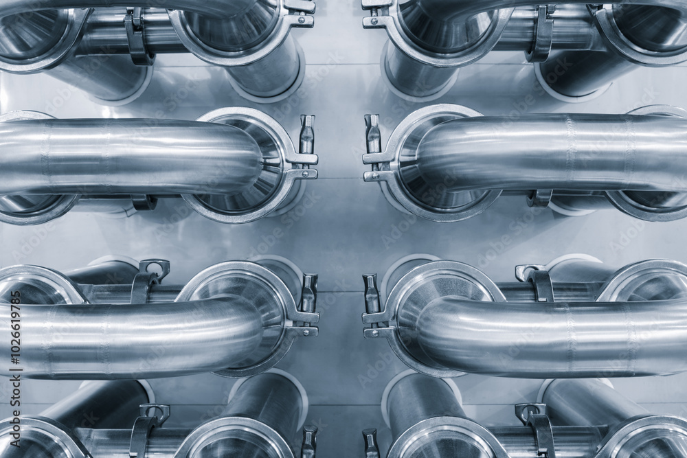 Aufkleber dairy machine cooling radiator with a row of stainless steel metal pipes with silver trim. the pipes