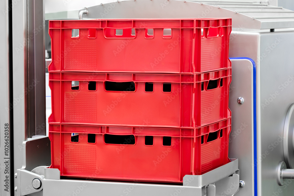 Aufkleber red plastic containers are stacked on top of each other. the containers are made of plastic and have