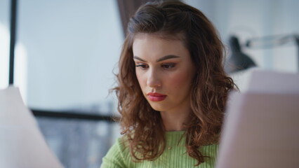 Confused manager doing paperwork in modern office closeup. Woman finding mistake