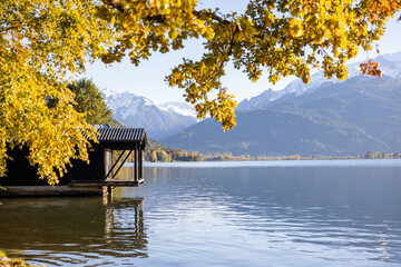 Lake Zell in the fall during the sunset. Snowy mountains and colourful foliage. Idyllic autumn scene in the Austrian Alps
