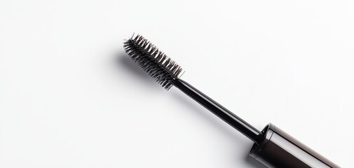 Brow gel tube with a brush applicator, the brush slightly pulled out, revealing the product, against a clean white backdrop