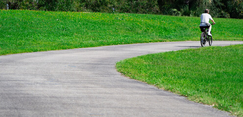 man riding bicycle on road