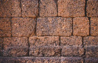 Ancient laterite brick wall for abstract seamless background and texture. beautiful patterns, space for work, close up.