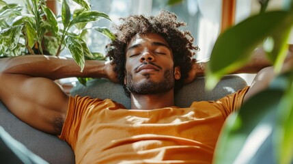 A relaxed man lounges on a couch surrounded by green plants. His serene expression conveys a moment of peace, emphasizing the harmony between nature and relaxation.