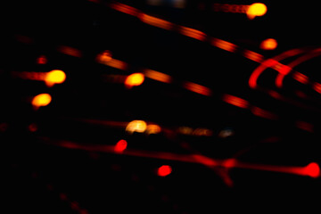A blurry image of lights and lines in the dark. The image is abstract and has a moody atmosphere