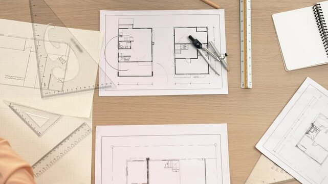 Video of clever architect or engineer using measurement tool and pencil compare a hand draft detail blueprint for construction accuracy at architectural office. Focus on hand. Closeup. Delineation.