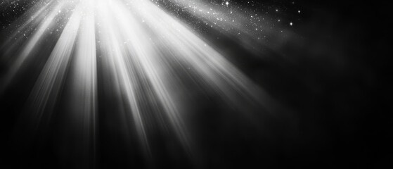  A monochrome image of light beaming from a central source against a black backdrop