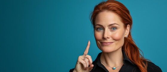 Obraz premium A person smiles while placing a finger beside her face in a close-up shot