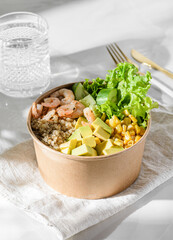 bowl with shrimp and quinoa in an ecological box