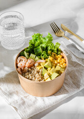bowl with shrimp and quinoa in an ecological box