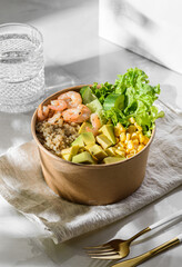 bowl with shrimp and quinoa in an ecological box