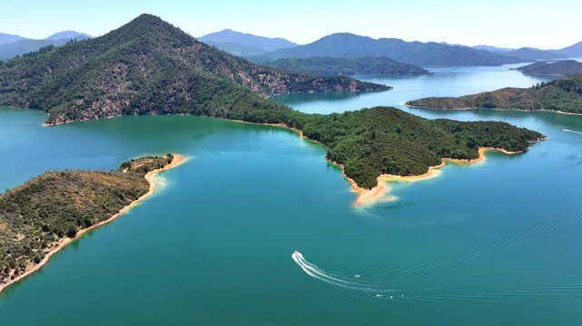 Shasta Lake - Aerial Follow of Boat Going Around Island in Summer