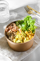 bowl with shrimp and quinoa in an ecological box