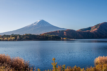 Mount Fuji during a sunny day in autumn season on lake Kawaguchi