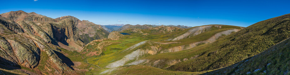 tundra valley with cliff walls and distant mountain range