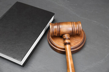 Book and judge's gavel on gray textured table