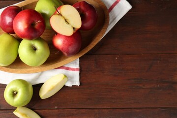 Fresh red and green apples on wooden table, flat lay. Space for text