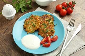 Delicious potato pancakes served on wooden table, closeup