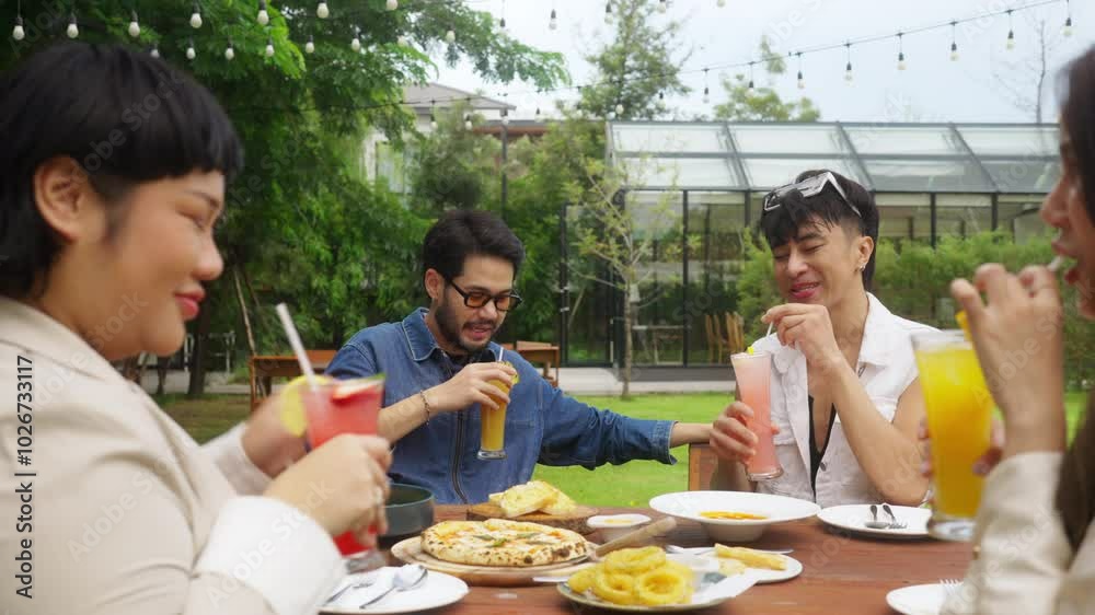 Wall mural Group of Happy Asian millennial generation people friends enjoy and fun toasting cocktail glasses celebration reunion meeting at outdoor dinner party in the garden at restaurant on holiday vacation.