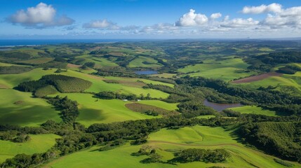 Obraz premium Aerial View of Rolling Green Hills and Lush Vegetation with Two Lakes in the Distance