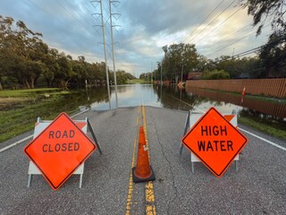 Road Closed. Stop road sign. High Water sign. Florida tropical storm. Hurricane flood road blocked...