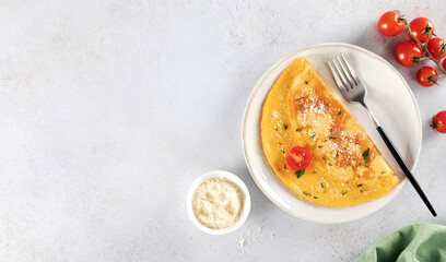 Eggs omelette with cheese, tomato and parsley on a white background. Top view. Copy space.