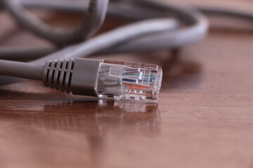 Close up the ethernet network cable. Curved ethernet cable plug connector Network connection, internet communication and computer technology concept. Gray LAN wire.
