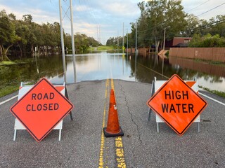 Road Closed. Stop road sign. High Water sign. Florida tropical storm. Hurricane flood road blocked...