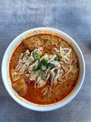 A bowl of spicy chicken laksa.