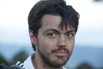 portrait of a man with black hair and kind eyes