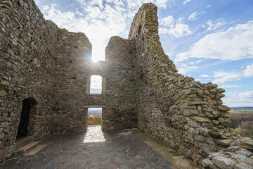 Two old stone walls of Devin Castle in backlight, facing daylight, slightly cloudy sky, Slovakia, wide angle lens