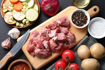 Cooking stew. Uncooked meat and vegetables on black table, flat lay