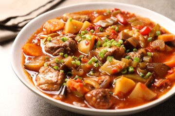 Delicious stew with vegetables in bowl on table, closeup