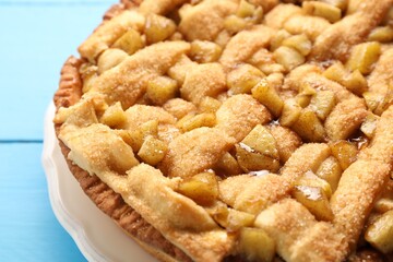 Tasty homemade apple pie on light blue table, closeup