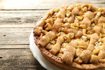 Homemade apple pie on wooden table, closeup