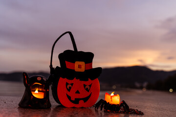 Concept: Halloween beach and ocean background with spider, witch and ghost pumpkin. Dark, scary tone.