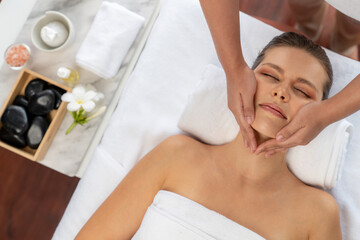 Panorama top view of woman enjoying relaxing anti-stress head massage and pampering facial beauty skin recreation leisure in dayspa modern light ambient at luxury resort or hotel spa salon. Quiescent