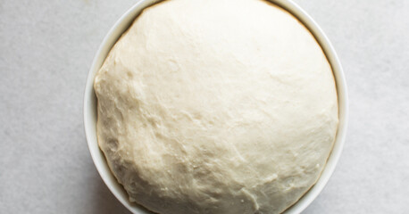 Overhead view of proofed challah bread dough, process of making challah