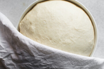 Overhead view of proofed challah bread dough, process of making challah