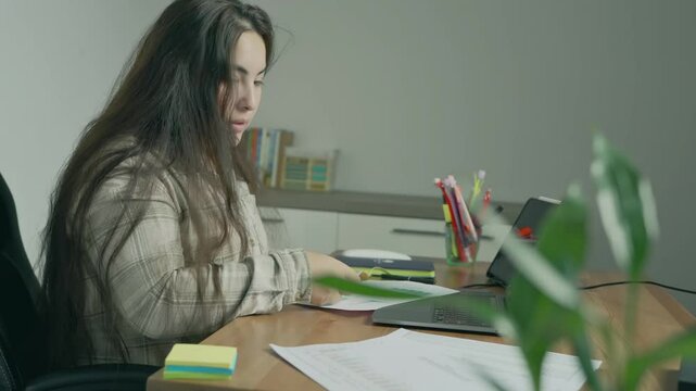 young woman study hard overnight brownout bored remote learn online read data tired sitting head in hands at home office desk workplace think worry in job tough stress workforce issue. High quality 4k