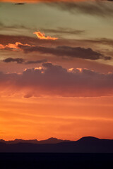 stunning sunset over Suasi Island. The sky transforms into a canvas of colors, reflecting the beauty and serenity of this magical place. Titicaca Lake Peru