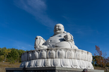 Peterborough, Ontario, Canada - October 12, 2024:
Maitreya Buddha (Happy Buddha) statue in Wutai Shan Buddhist Garden. Peterborough, Ontario, Canada. 