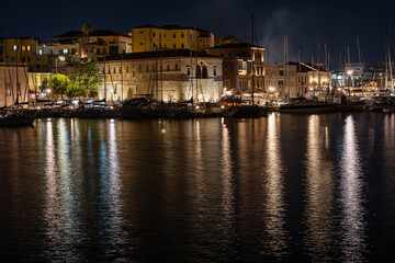 Chania harbor with boats and illuminated houses, night, Greece, Crete island, normal angle lens