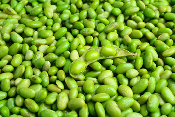 Fresh edamame beans and pod as background, closeup