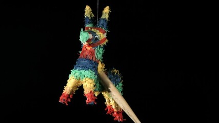 pinata is hit until it breaks in slow motion