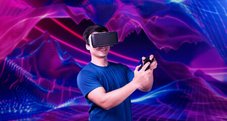 Professional gamer wearing VR headset while holding joystick at pink and purple gradient background. Skilled player with casual cloth and using augmented reality technology at background. Ingenuity.