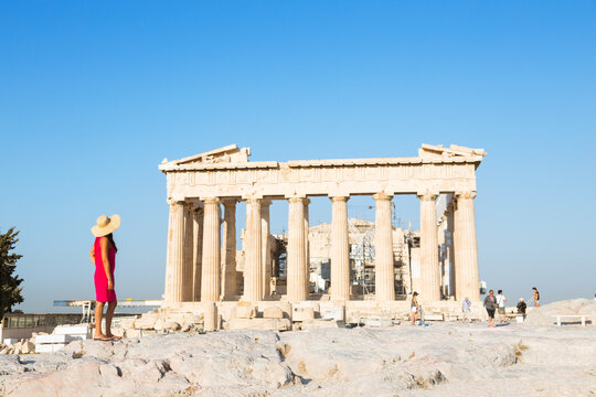 Woman looking at the famous Parthenon temple on the Acropolis, Athens, Greece