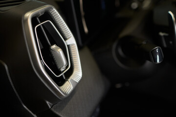 Closeup of car dashboard air vents near gear shift