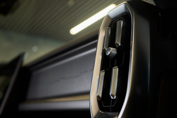 Closeup of car dashboard air vents near gear shift