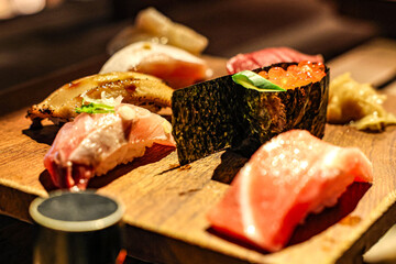Gourmet Sushi Platter with Nigiri and Ikura. A close-up of a beautifully presented sushi platter featuring a variety of gourmet nigiri and gunkan-maki topped with ikura.